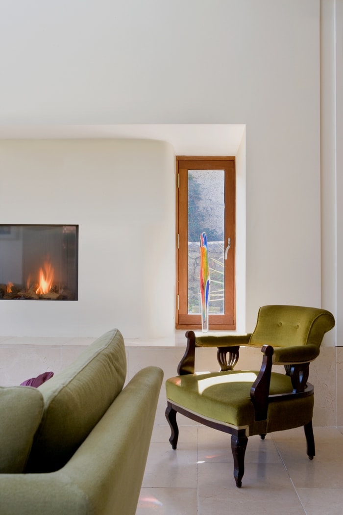 An east-facing window beside the fire admits early morning light