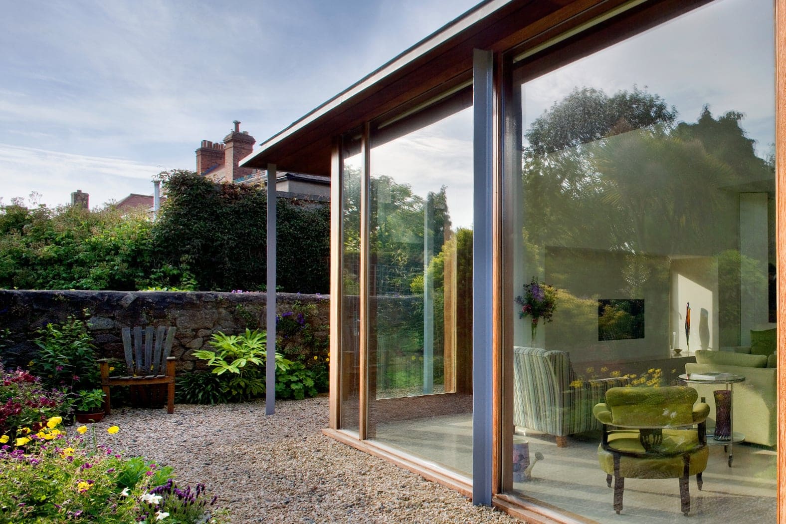 Glazed screen with thin metal roof and steel posts
