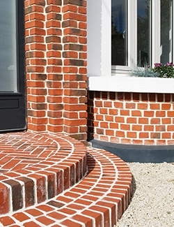 Close-up of elegant brick steps leading to a new entrance designed by Residential Architects