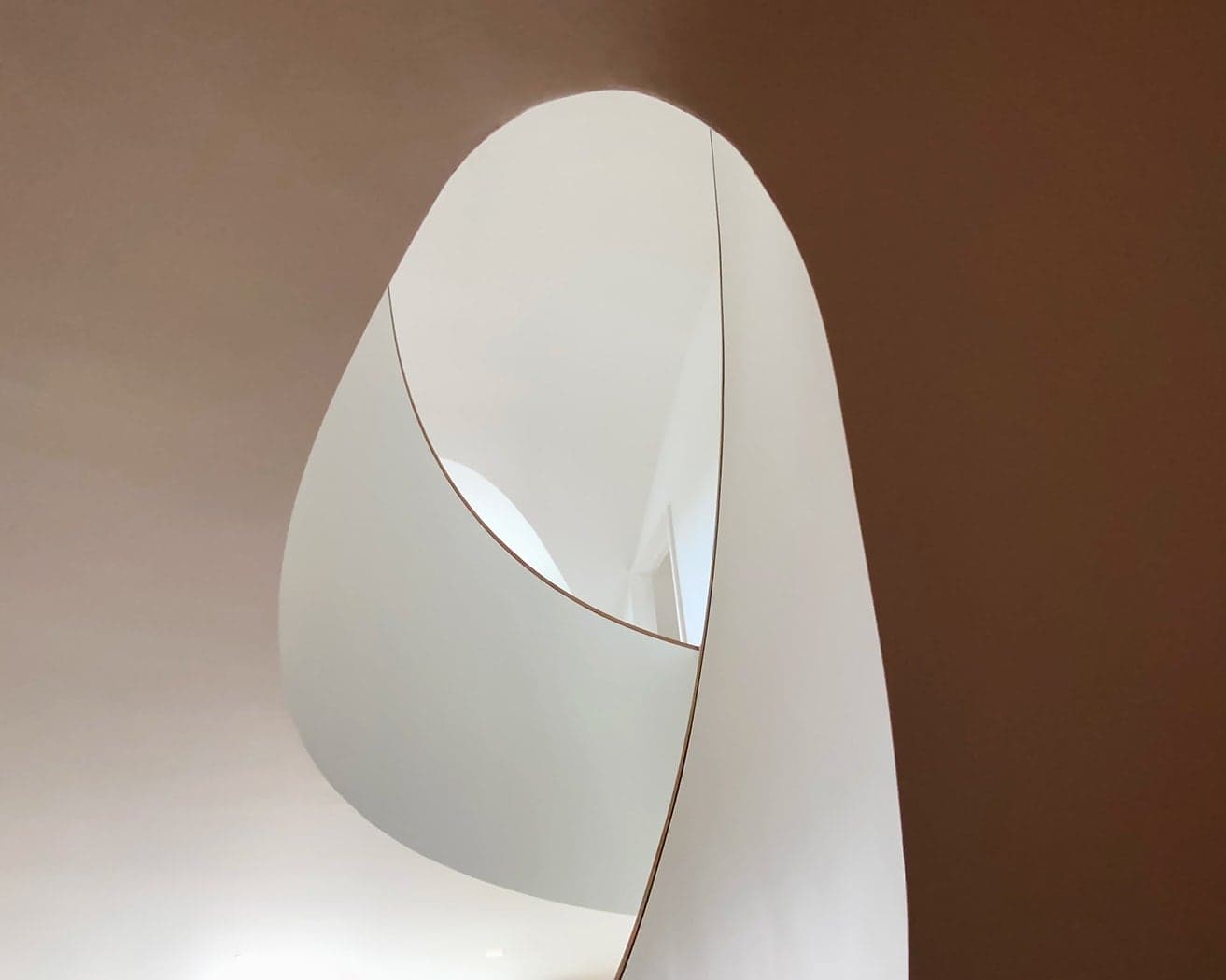 White minimalist interior of a newly built Dublin house with unique curvatures