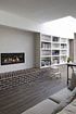 Living Room with gas fire, brick plinth, and open shelves