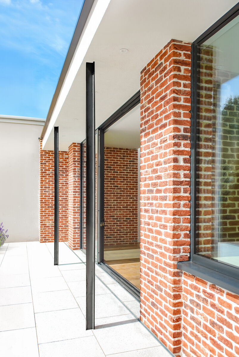 A canopy roof projection provides solar shading to prevent the interior from overheating