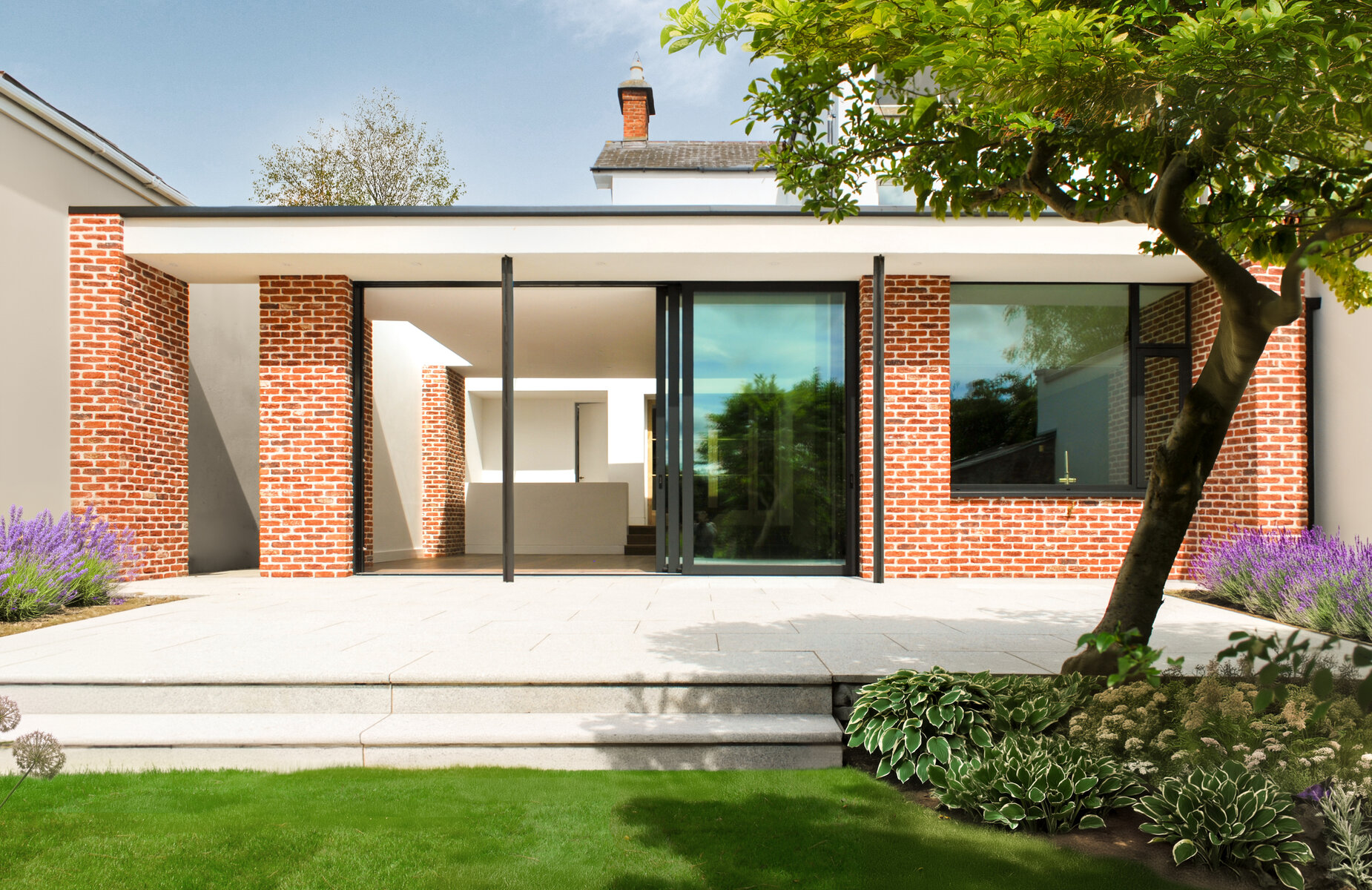 Contemporary addition to a Victorian home with brick piers and sleek Aluminium glazing