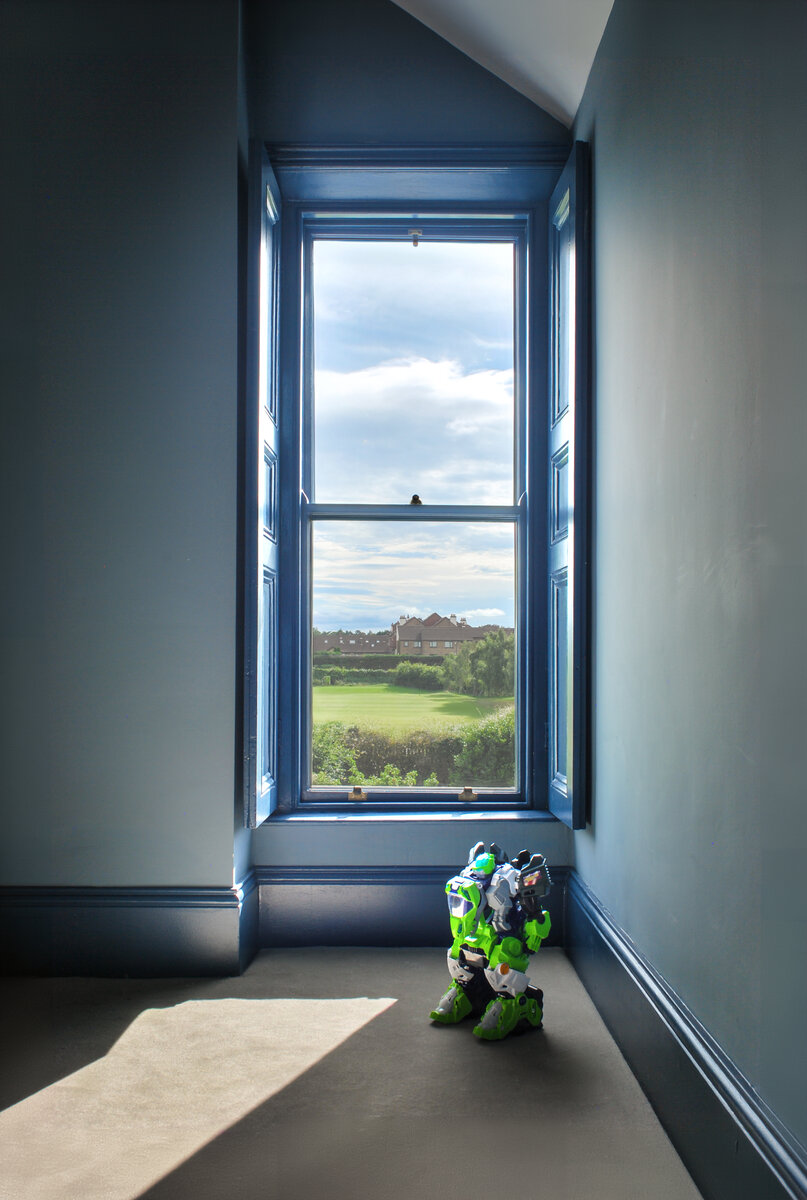 A child's bedroom with veiw through refurbished sash window