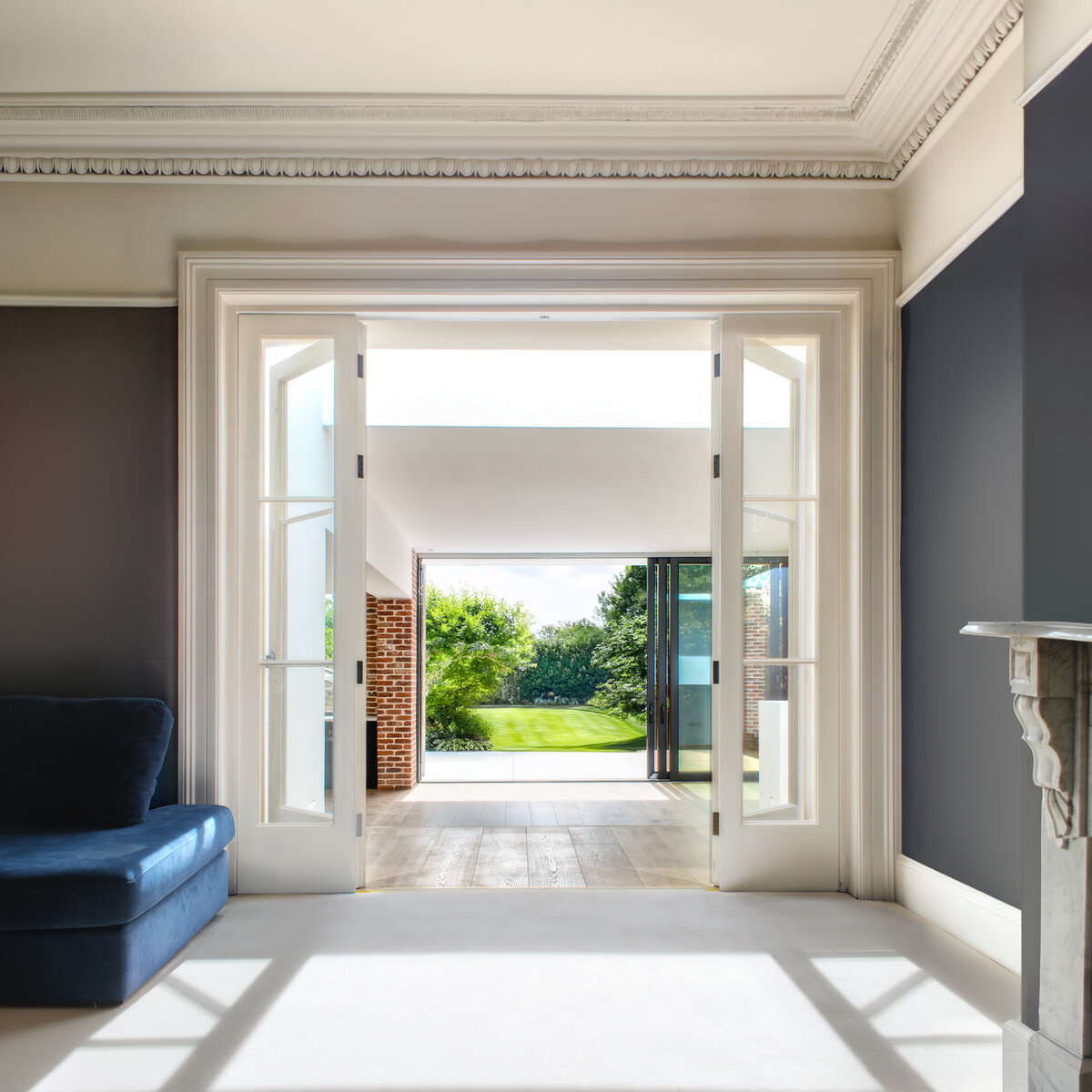 The interior of the original house is flooded with light from a very large new rooflight that sits between new and old