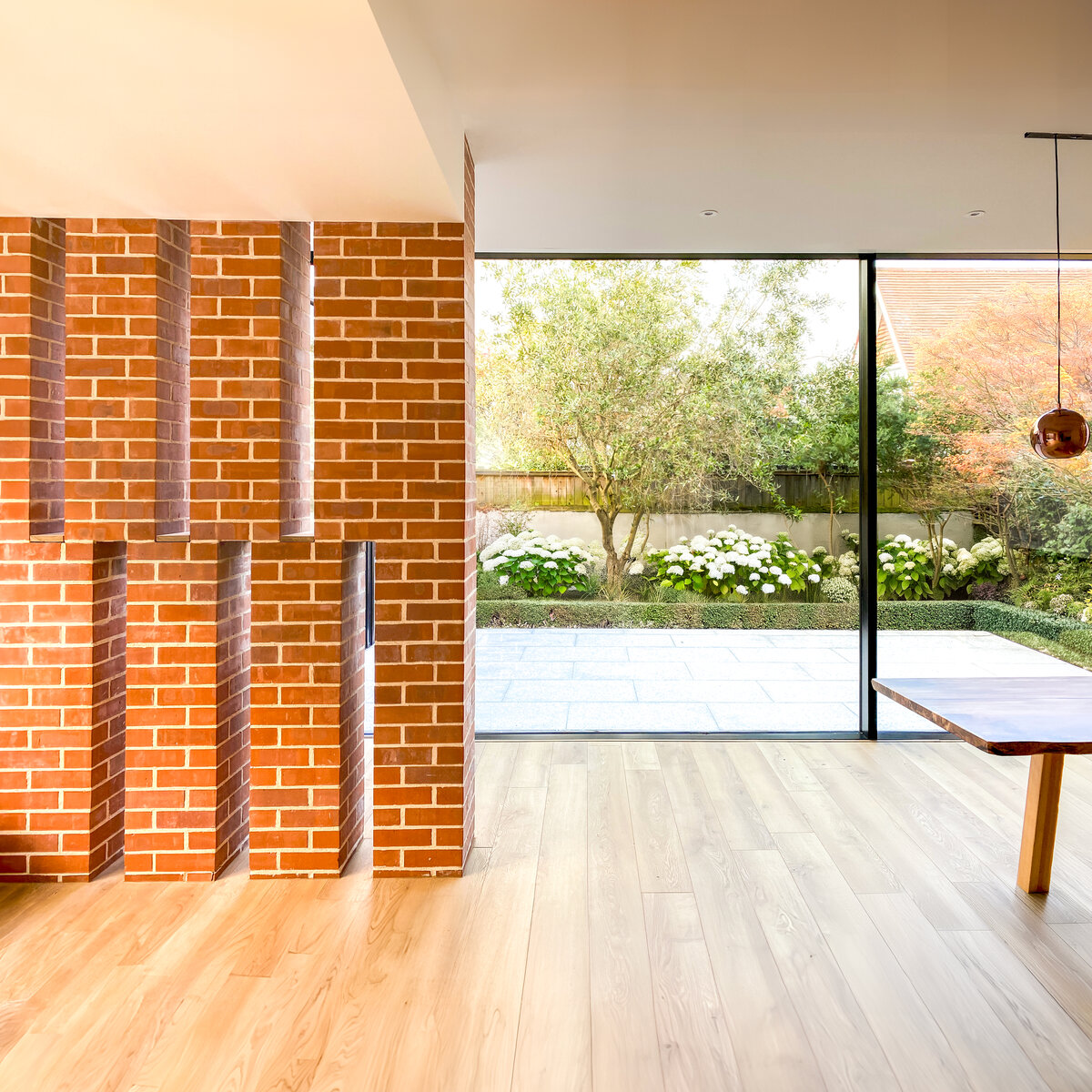 Interior view looking towards the rear garden garden. A brick screens provides privacy leading to the door of the accessible master bedroom