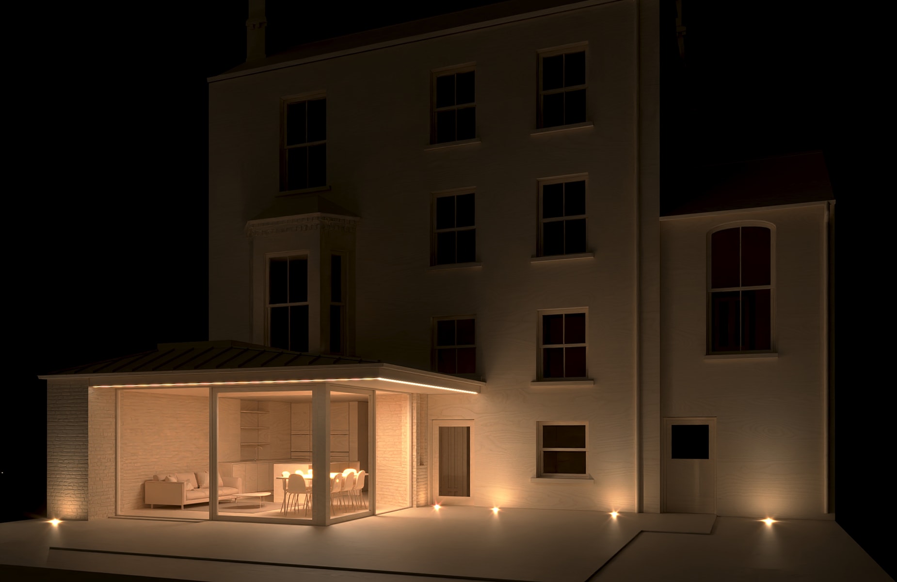 Rear garden elevation of period home at night