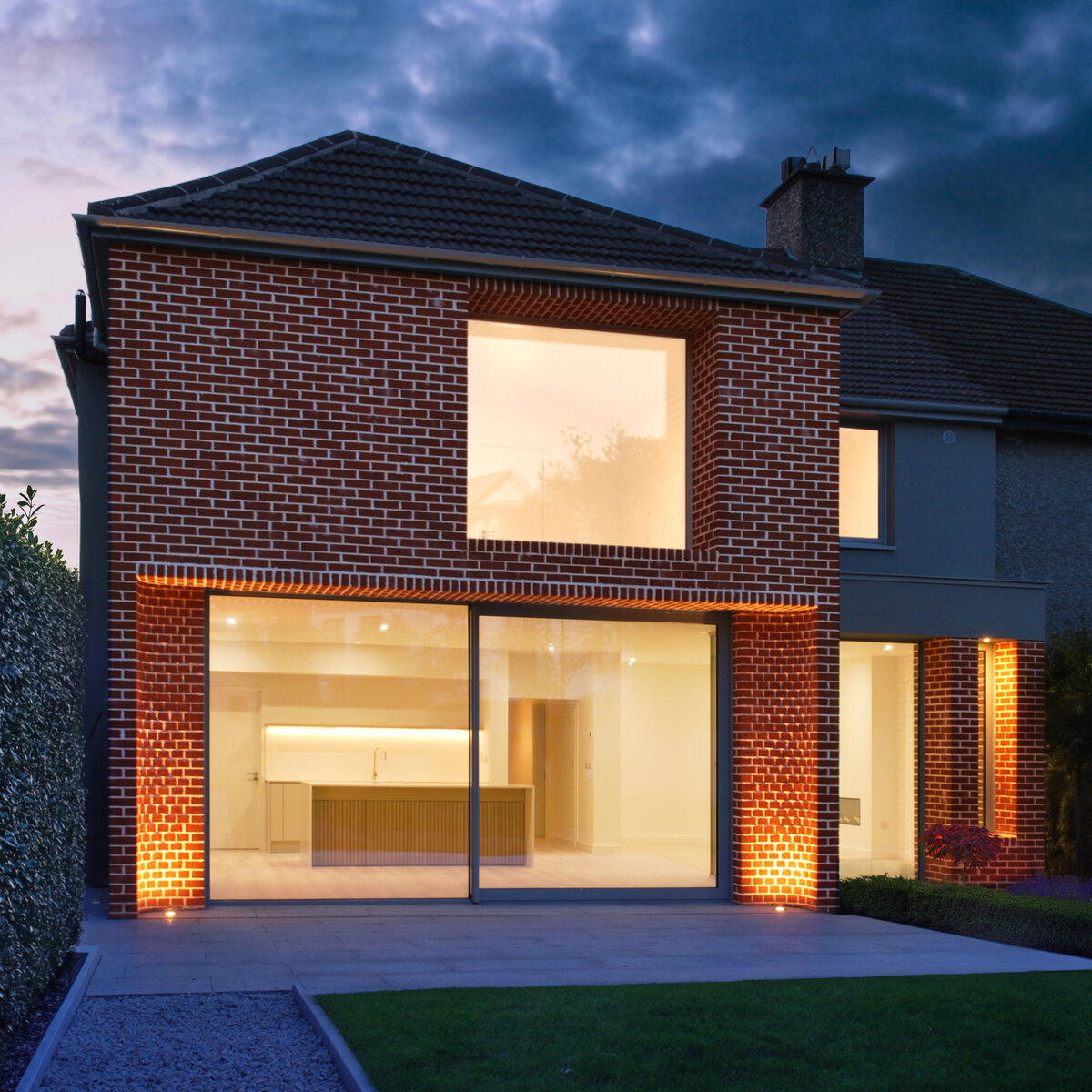 Dusk view of two storey brick extension