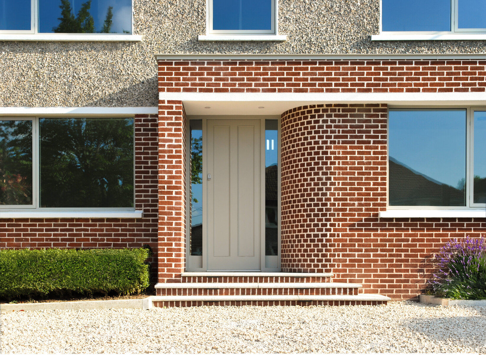 Covered porch formed by pier brick and curved brick wall