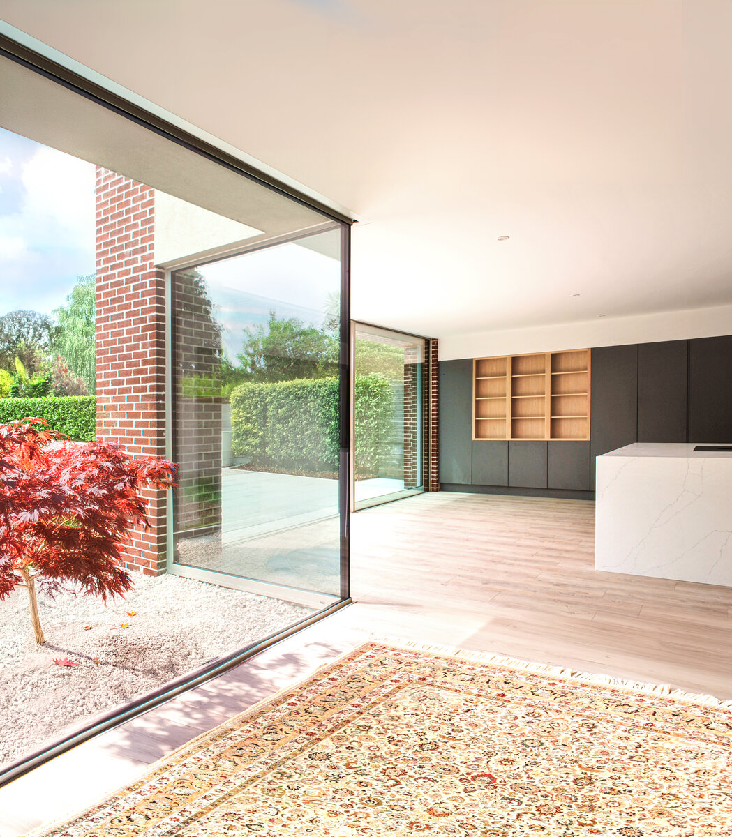 Modern living dining space with corner window and glazed sliders