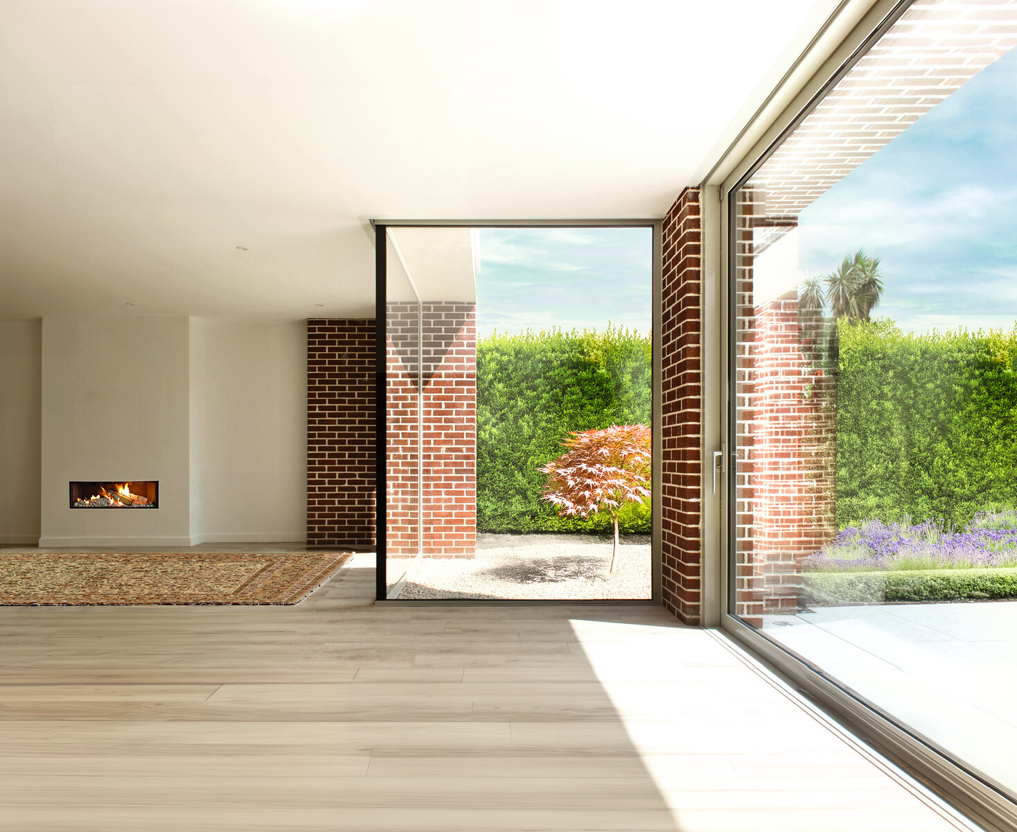 Corner window and glazed sliders between brick piers in Living space