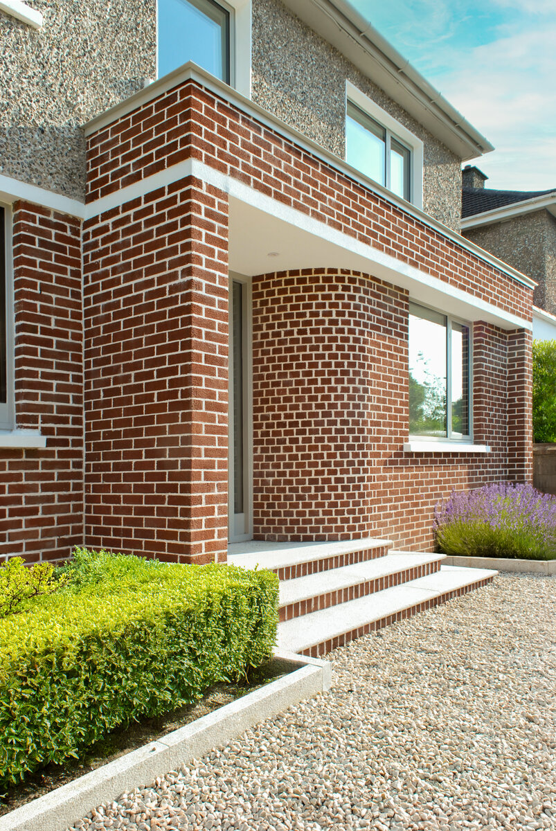 Modern covered porch with curved brickwork and brick steps