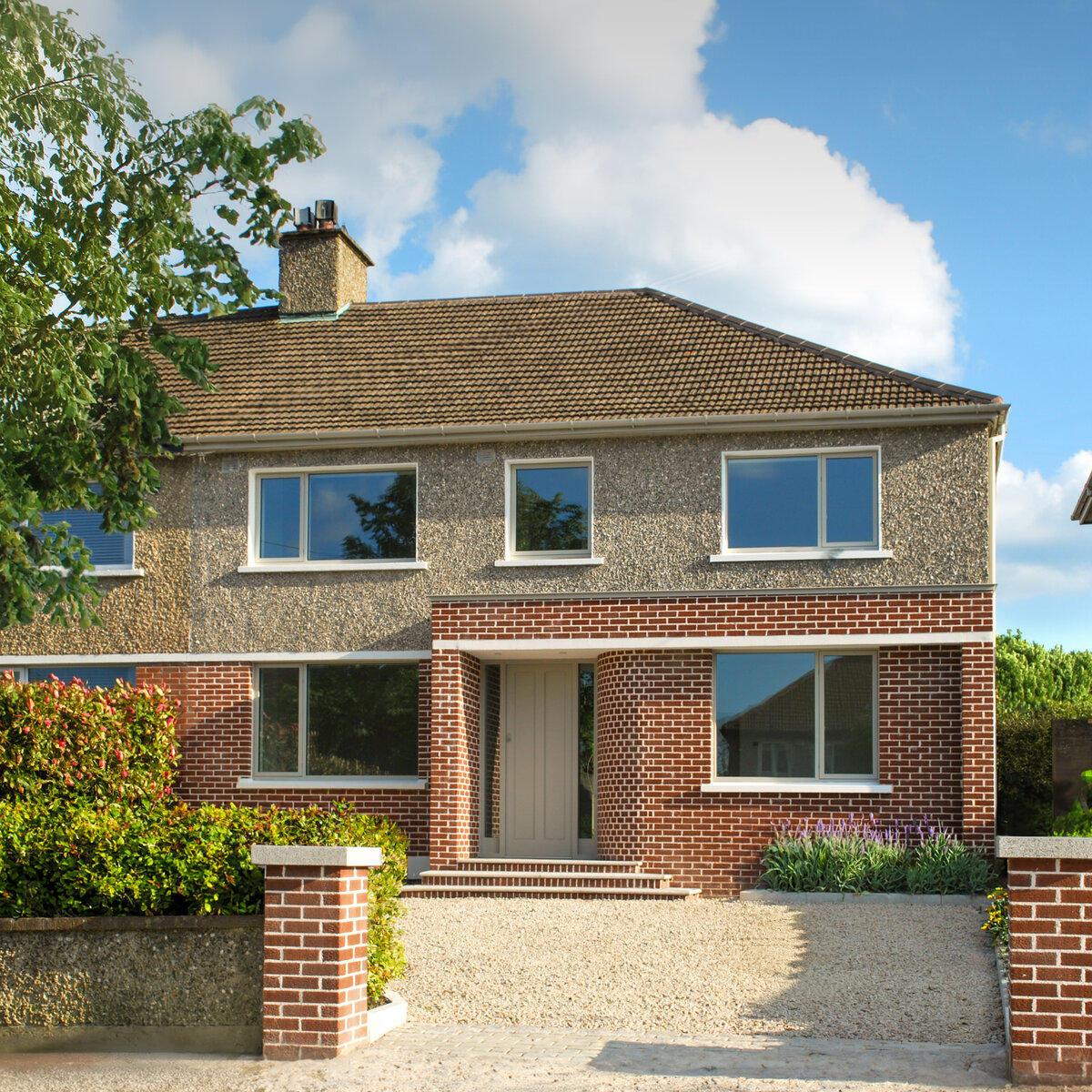 Front elevation of house with seamless side extension