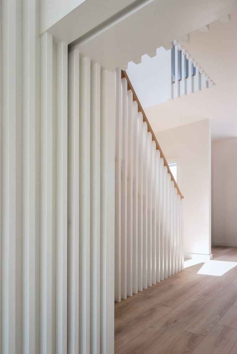 View to front of house through toplit stair hall