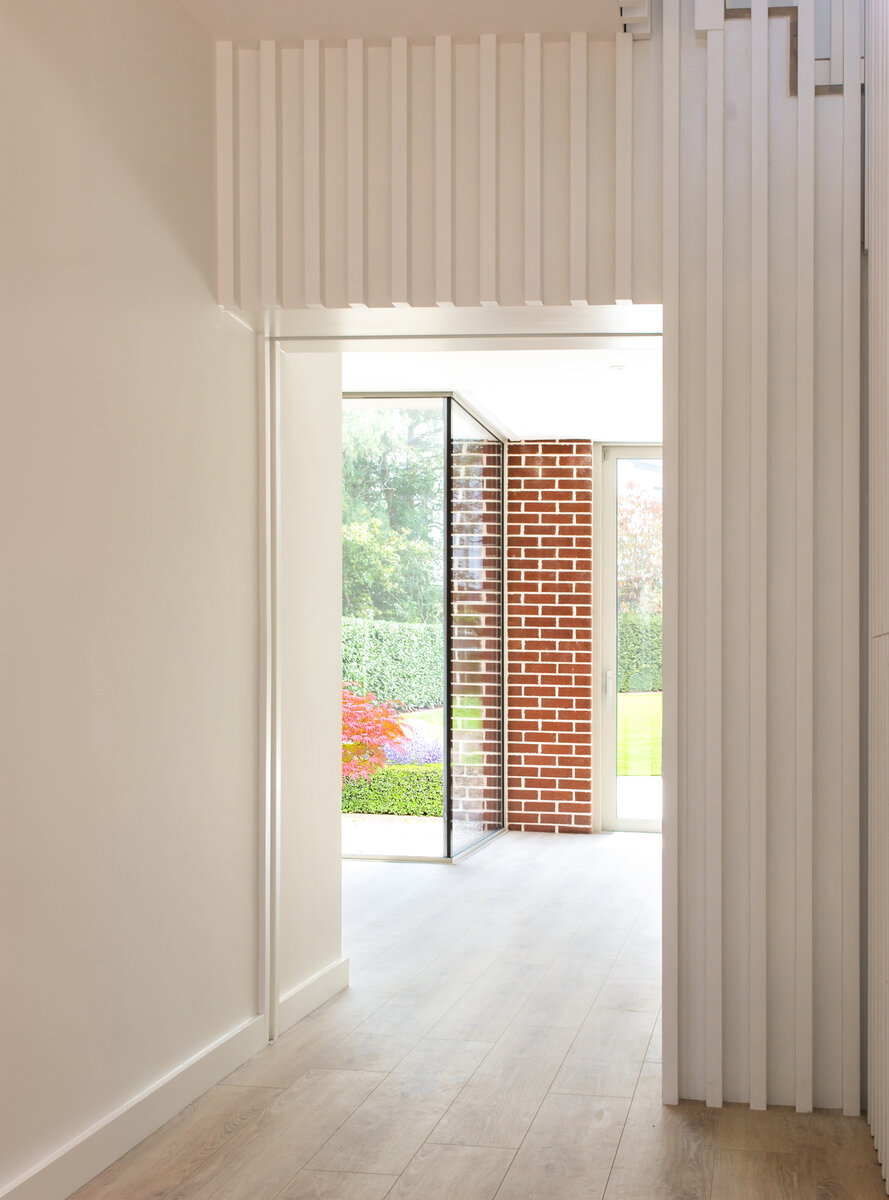 View through entrance hall to living spaces and garden