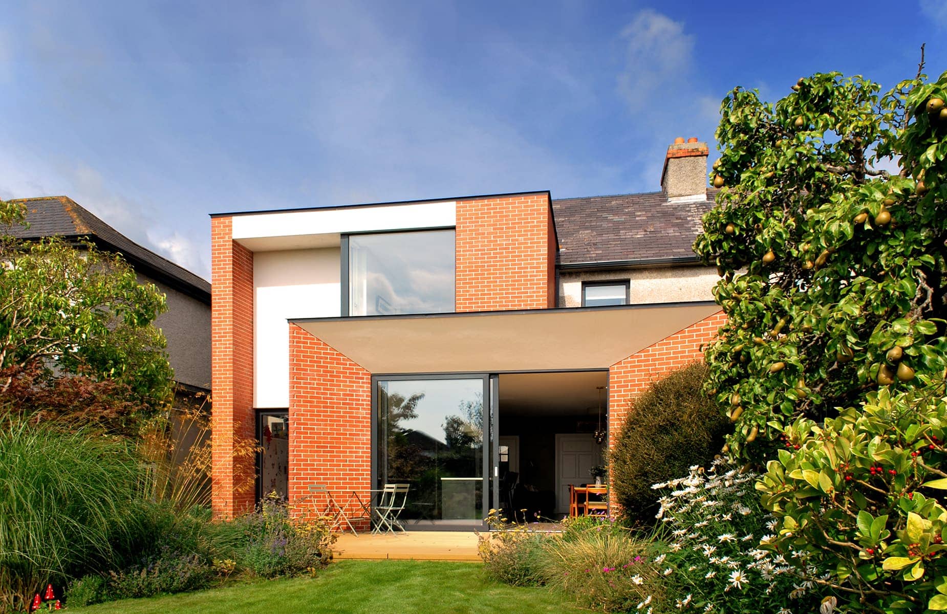A beautiful modern house in Dublin, designed by architects, with a brick exterior and a lush garden
